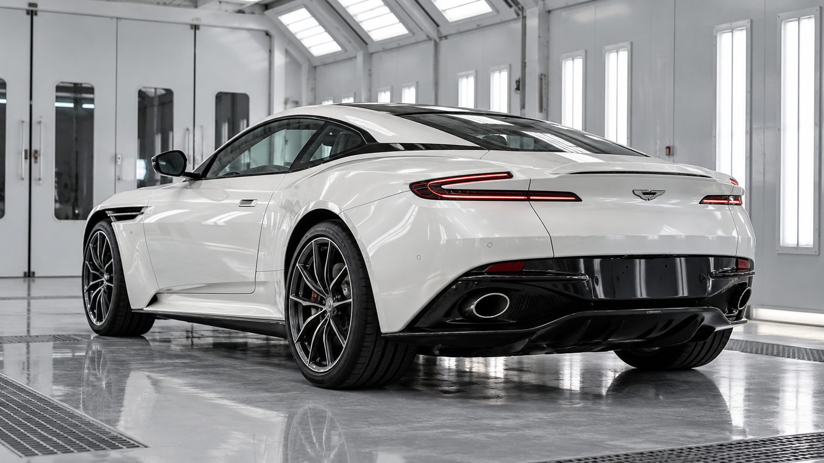 Pearl white Aston Martin DB12 in a paint finishing bay